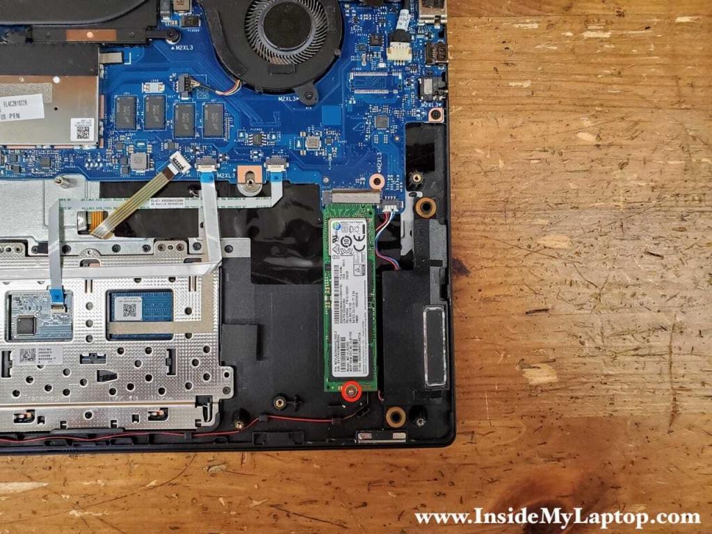 Remove one screw securing the solid state drive (SSD).