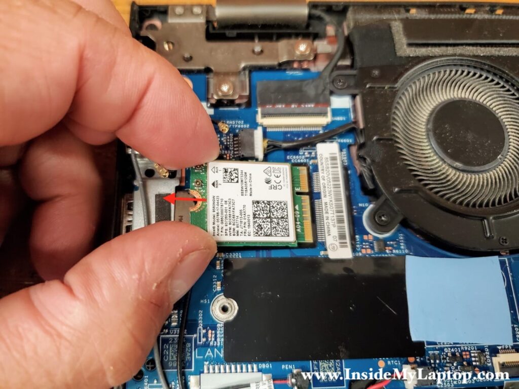 Pull the wireless card out of the slot and remove it.