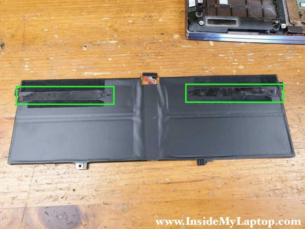 Original adhesive strips applied to the new battery.