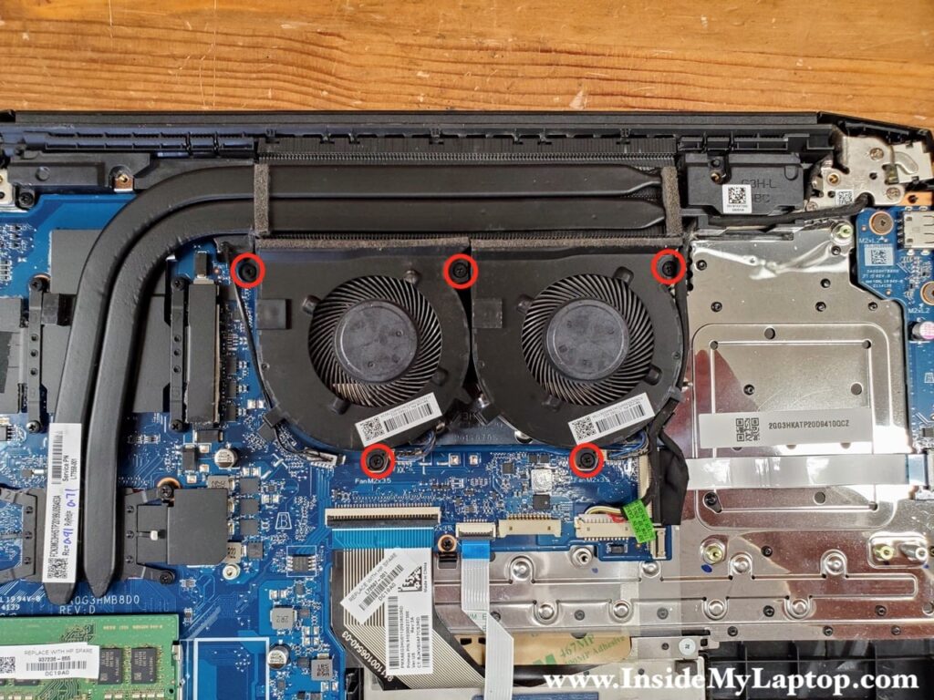 Remove five screws holding both cooling fans in place.