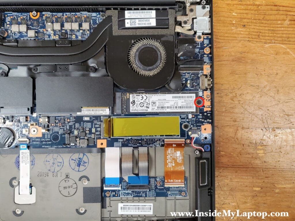 Remove one screw holding the solid state drive (SSD) in place.
