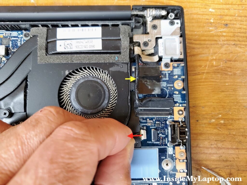 Separate the display cable and disconnect the fan.